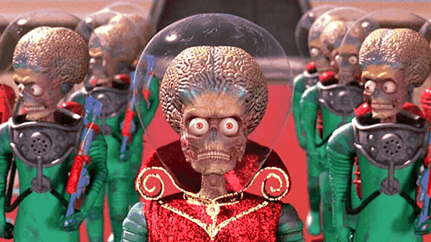 Some angry-looking CGI alien guys with big exposed brains exist their flying saucer toward the camera.