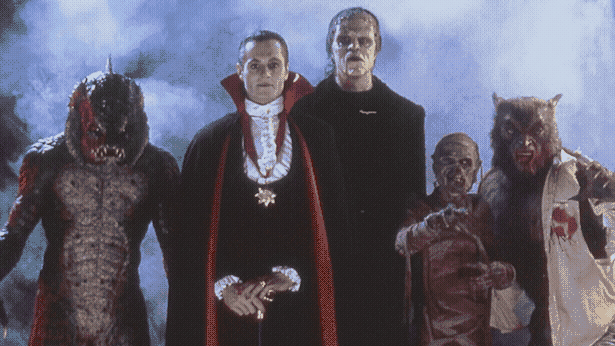 Fishman, Dracula, Frankenstein's Monster, a mummy, and the Wolfman emerge from some fog.