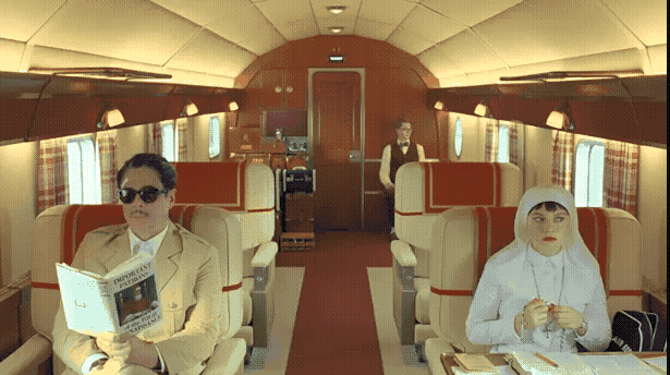 Benicio del Toro, left, and his in-movie daughter Mia Threapleton sit across the aisle of a small plane. Michael Cera is way back in the corner.