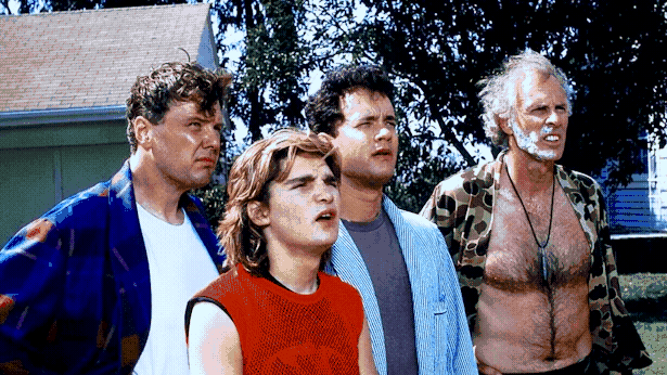 Rick Ducommun, Corey Feldman, Tom Hanks and Bruce Dern stand looking agog at something to the right