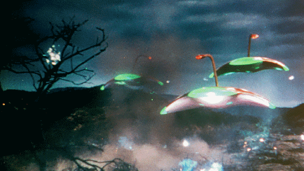 A screenshot from the film. Stingray-shaped alien machines with funny little eyestalks blast heat rays around at a miniature pastoral scene